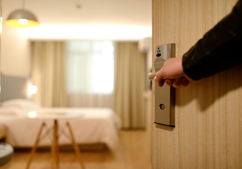 Person Holding on Door Lever entering a clean hotel room